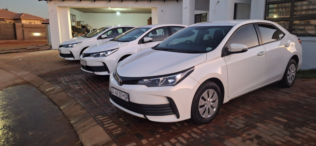 Toyota Corolla fleet parked in driveway at dusk