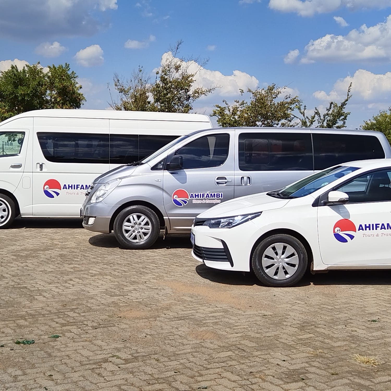 Ahifambi fleet: H1 van, Hyundai shuttle and Toyota Corolla sedan parked together